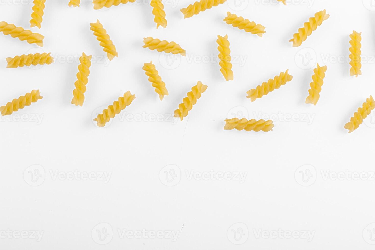 Pasta products in the form of a spiral, texture, on a white background photo