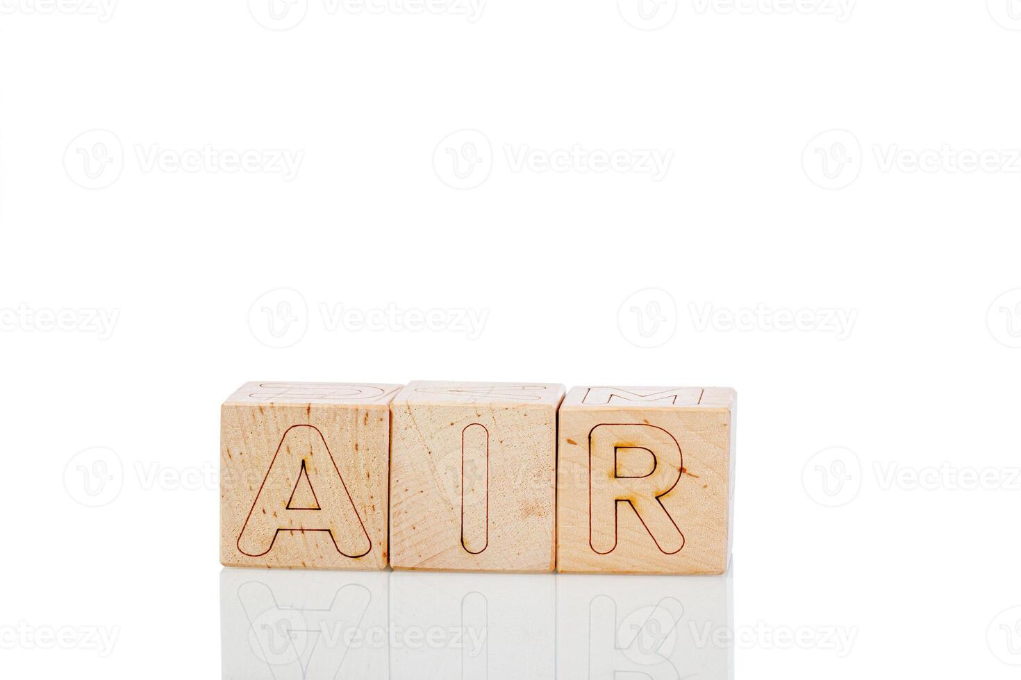 Wooden cubes with letters air on a white background photo