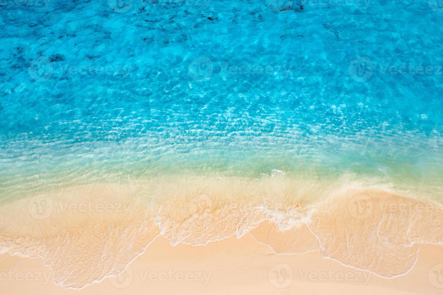 Summer seascape beautiful waves, blue sea water in sunny day. Top view from drone. Sea aerial view, amazing tropical nature background. Beautiful bright sea with waves splashing and beach sand concept photo