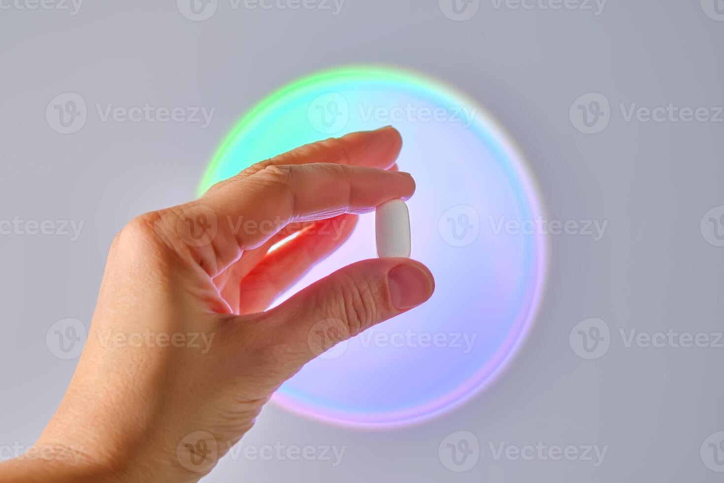 Tablet in hand against the background of a glowing circle. photo