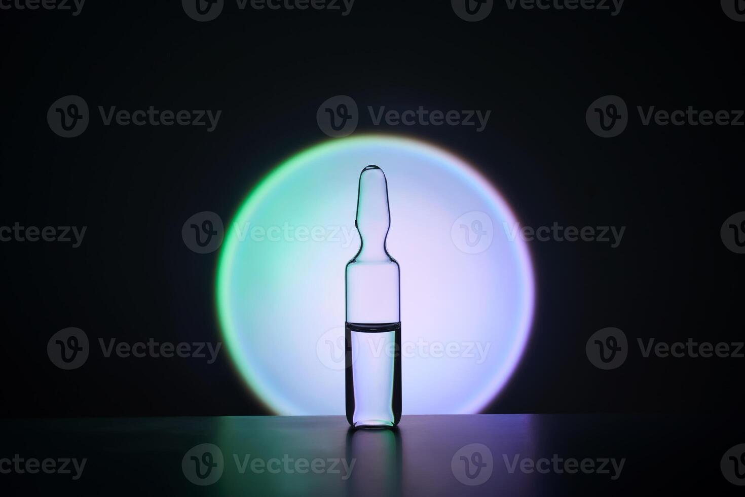 Ampoule for injection against the background of a bright blue circle. photo