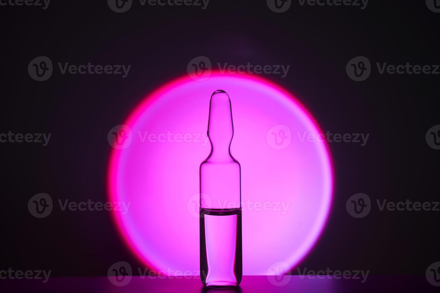 Several ampoules for injection with medicines on a lilac background. photo