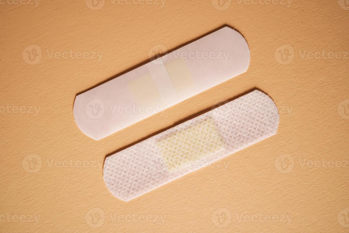 Adhesive plaster on a beige background on both sides. photo