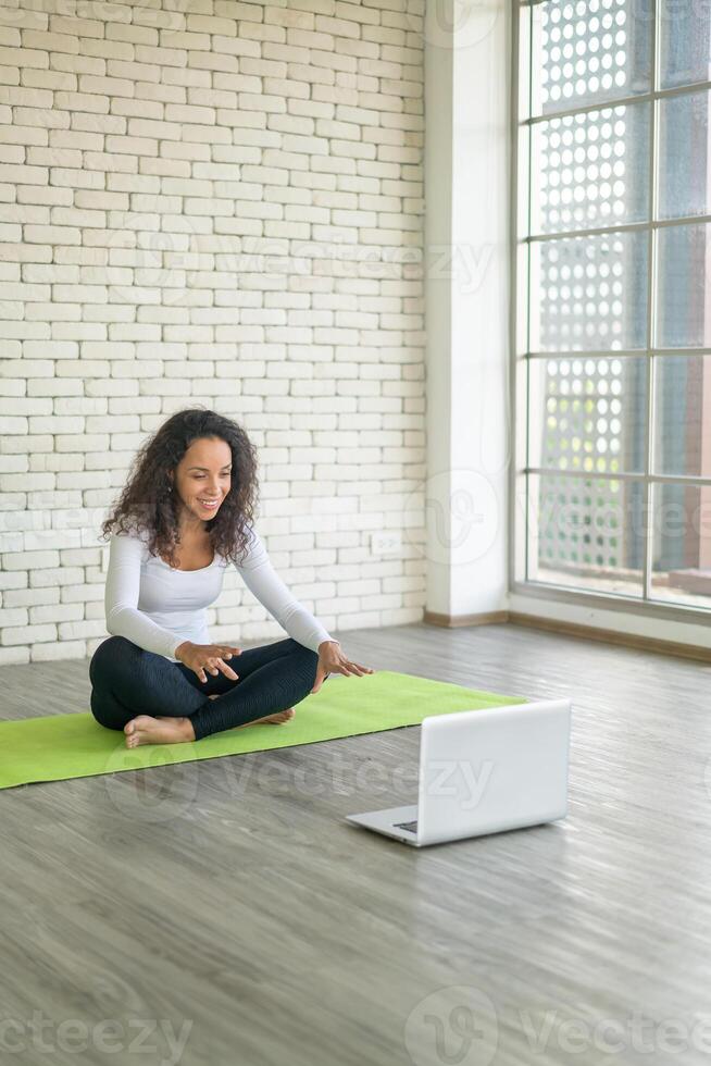 Latin woman teaching yoga online photo