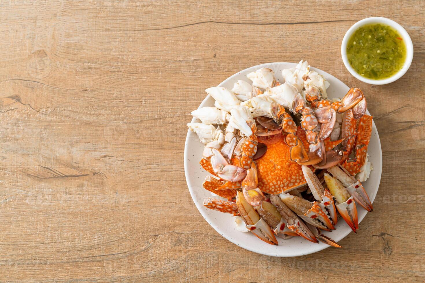 Steamed blue crab with spicy seafood sauce photo