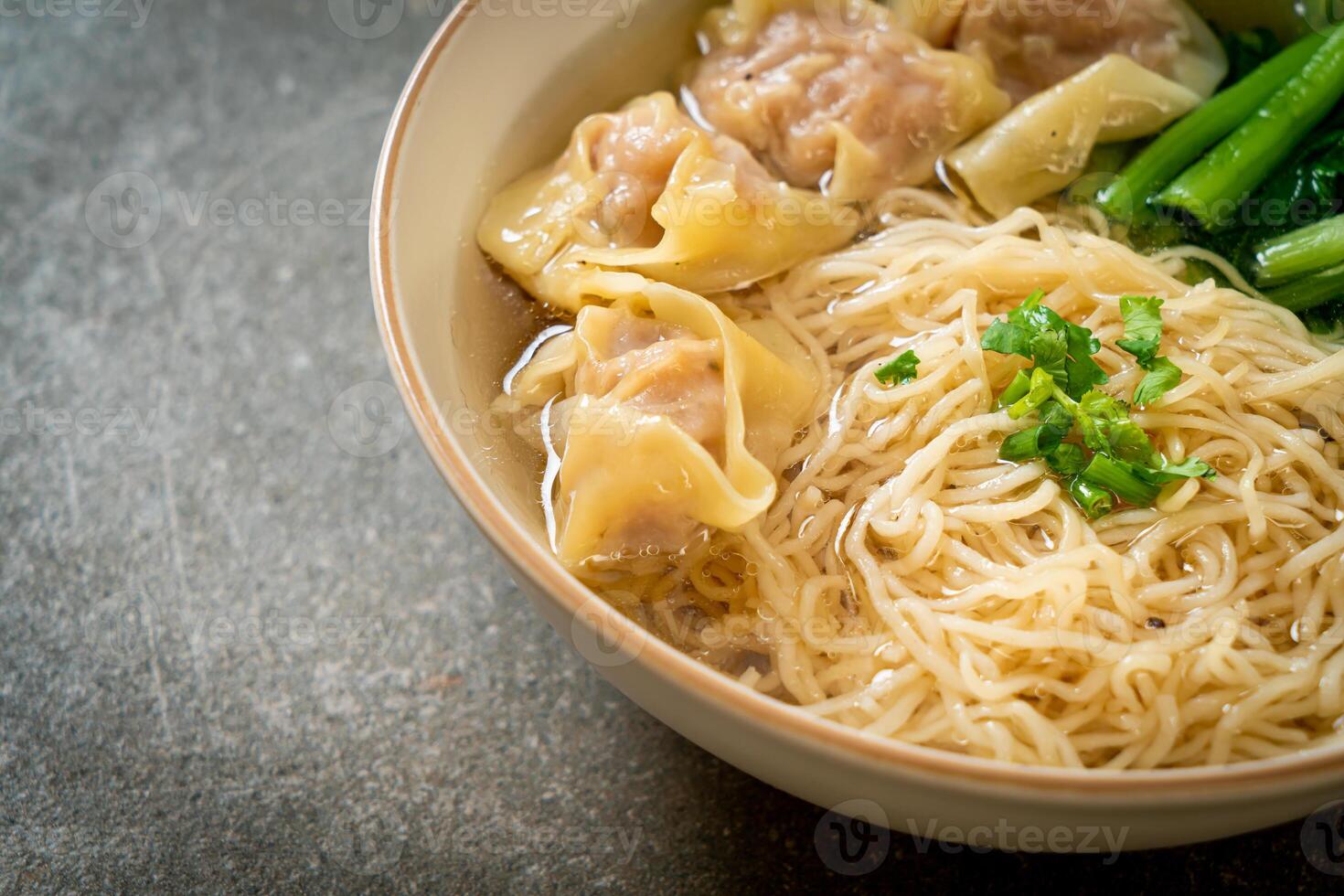 egg noodles with pork wonton soup or pork dumplings soup and vegetable photo