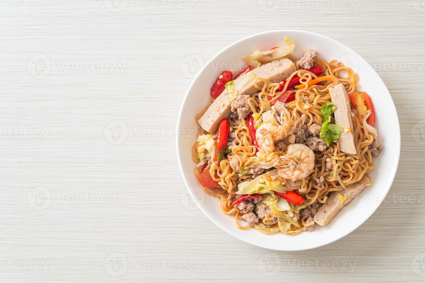 Instant noodles spicy salad on plate photo