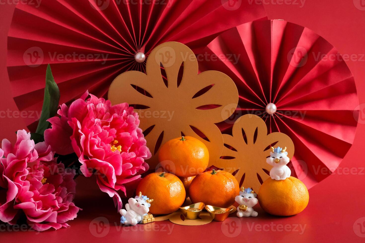 Chinese New Year of the dragon festival concept. Mandarin orange, red envelopes, dragon and gold ingot with red paper fans. Traditional holiday lunar New Year. photo