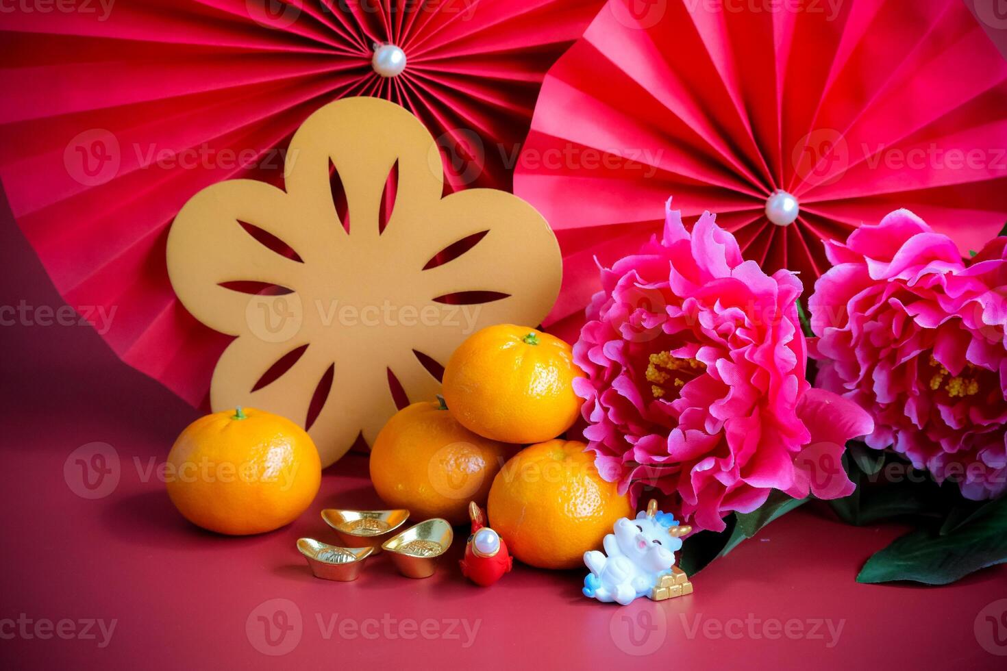 Chinese New Year of the dragon festival concept. Mandarin orange, red envelopes, dragon and gold ingot with red paper fans. Traditional holiday lunar New Year. photo