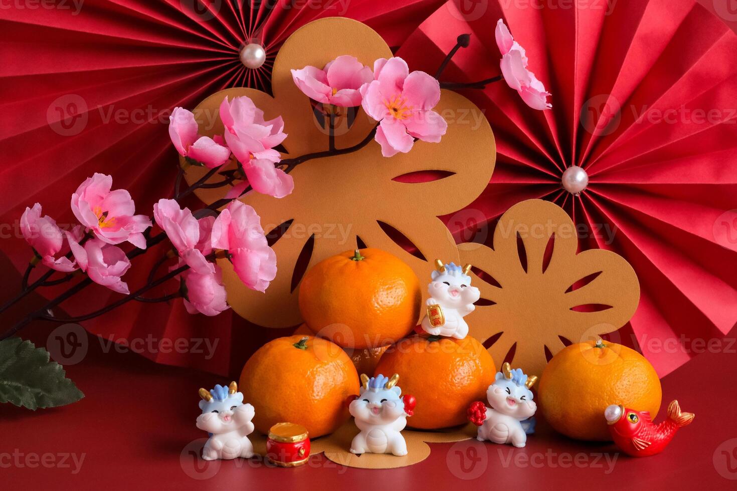 Chinese New Year of the dragon festival concept. Mandarin orange, red envelopes, dragon and gold ingot with red paper fans. Traditional holiday lunar New Year. photo