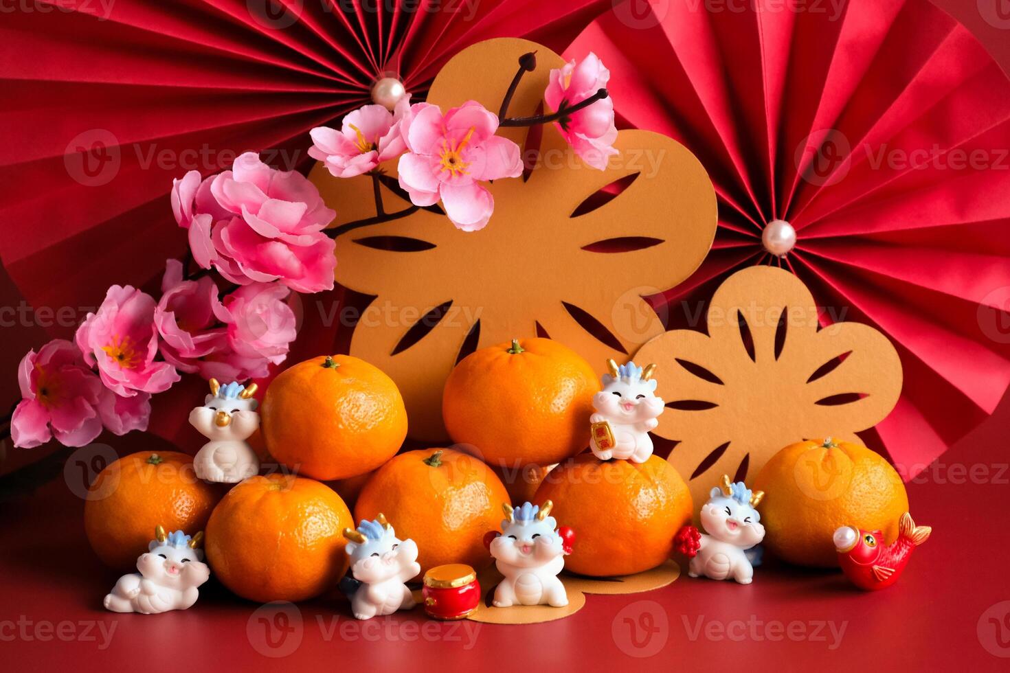 Chinese New Year of the dragon festival concept. Mandarin orange, red envelopes, dragon and gold ingot with red paper fans. Traditional holiday lunar New Year. photo