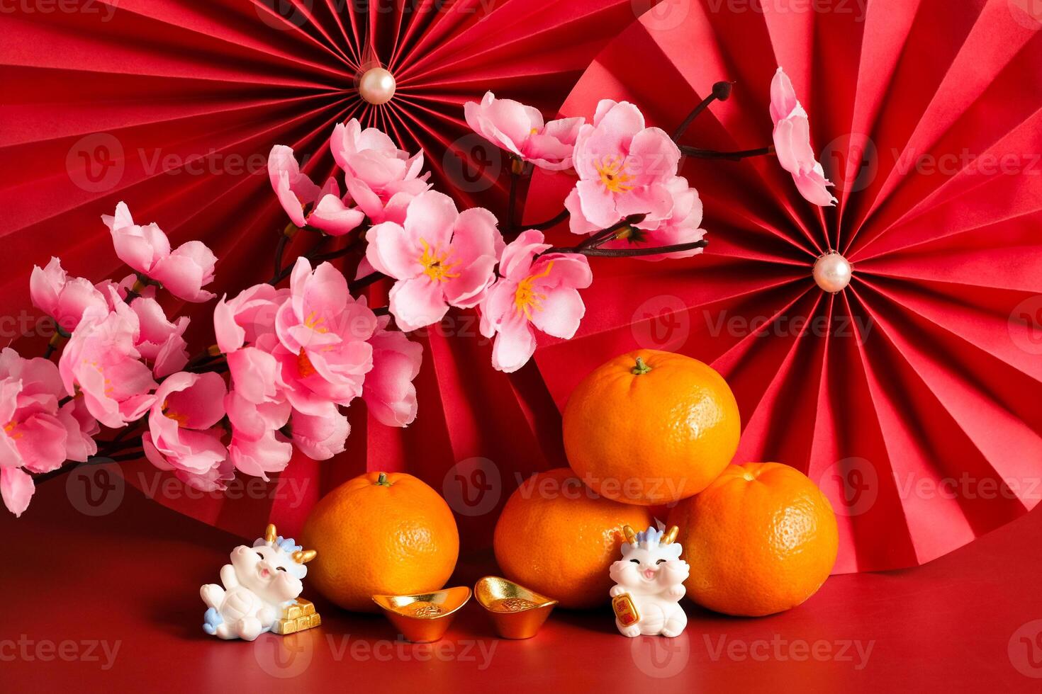 Chinese New Year of the dragon festival concept. Mandarin orange, red envelopes, dragon and gold ingot with red paper fans. Traditional holiday lunar New Year. photo
