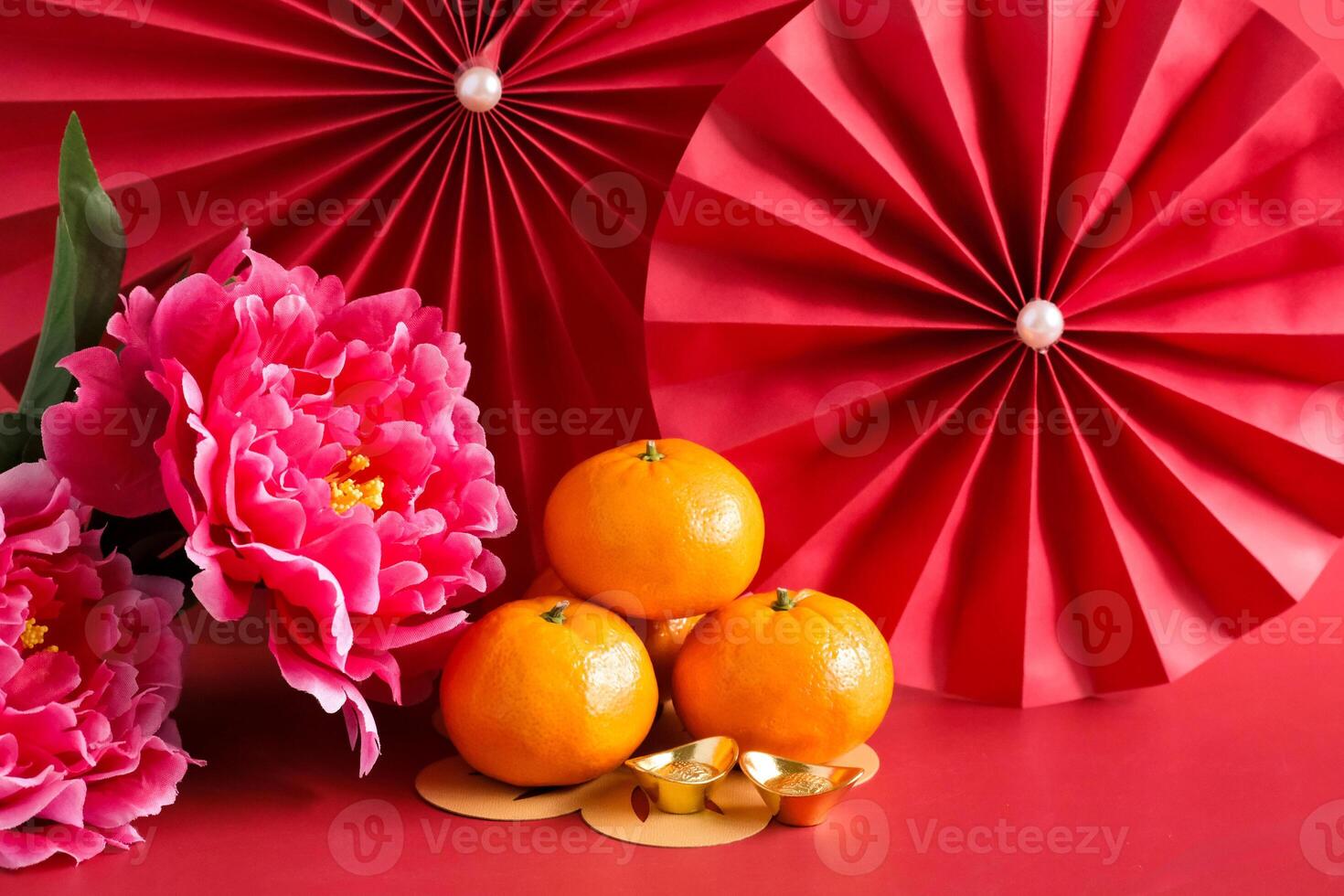 Chinese New Year of the dragon festival concept. Mandarin orange, red envelopes, dragon and gold ingot with red paper fans. Traditional holiday lunar New Year. photo