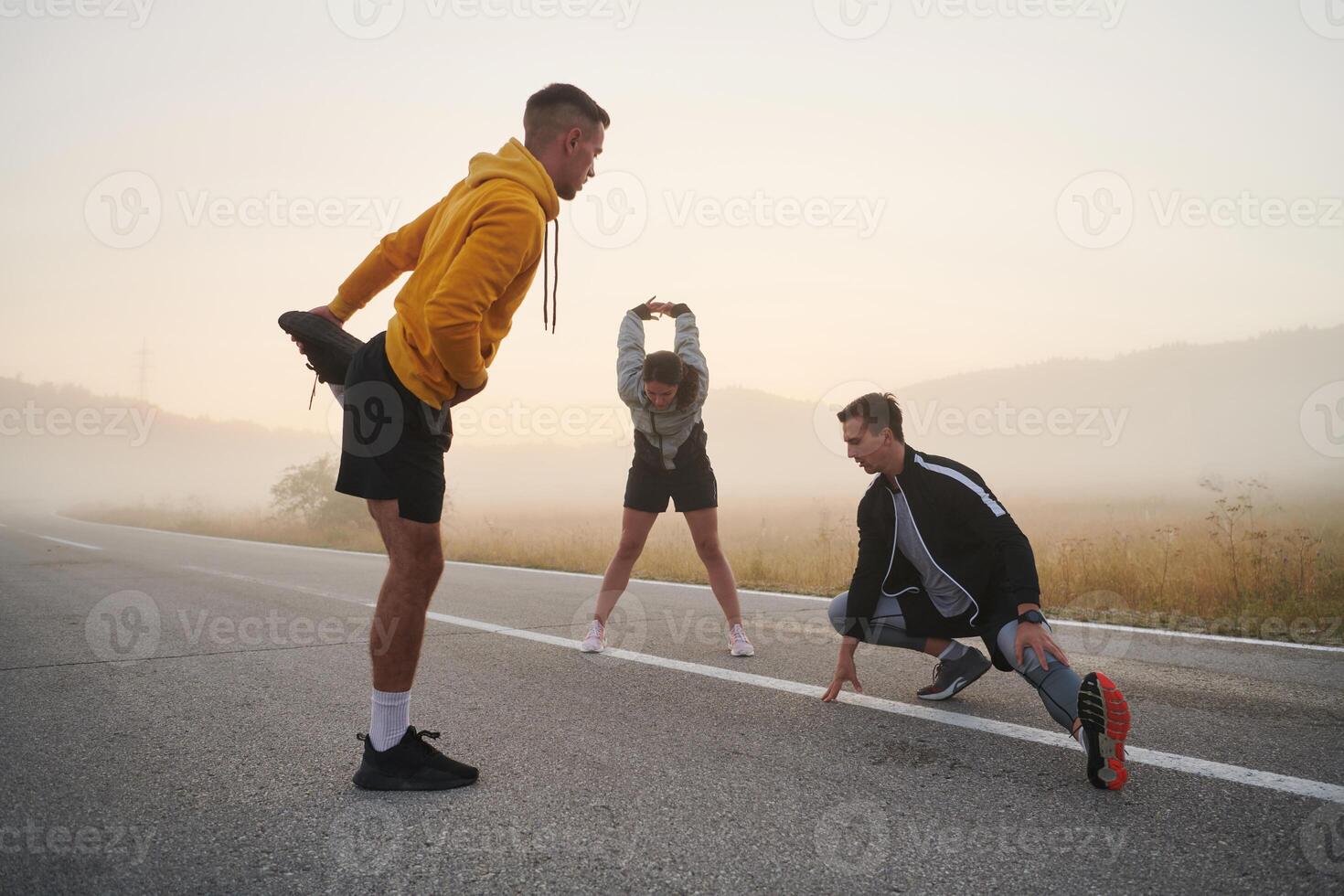 Diverse Athletes Prepare. Dynamic Group Warms Up for Morning Run. photo