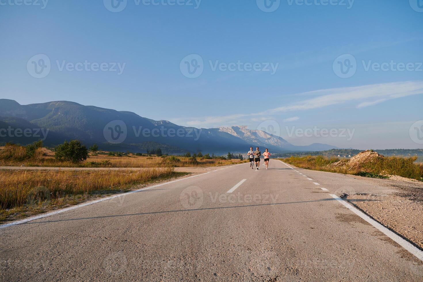A group of friends maintains a healthy lifestyle by running outdoors on a sunny day, bonding over fitness and enjoying the energizing effects of exercise and nature photo