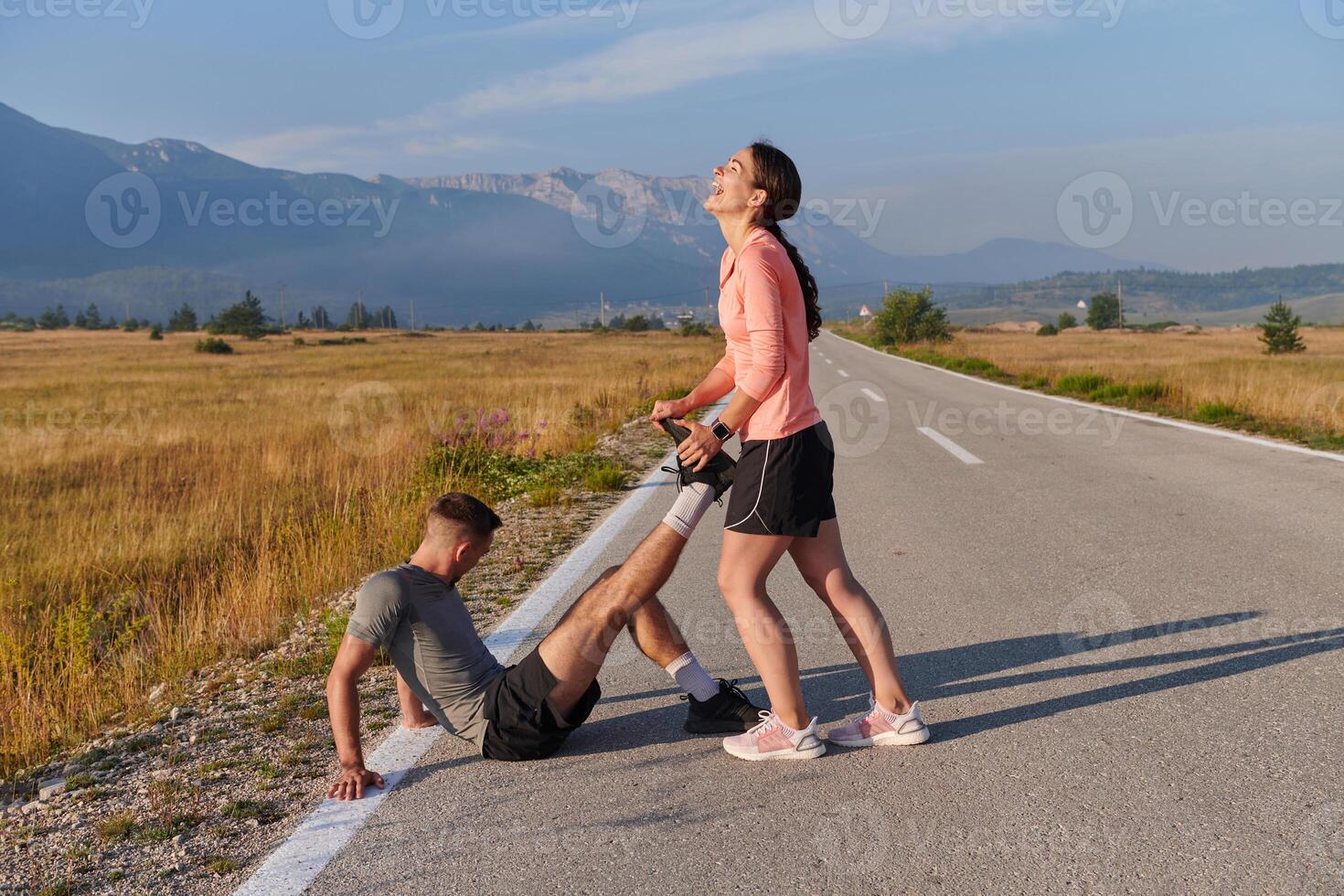 Morning Stretch. Romantic Couple Prepares for Early Morning Run photo
