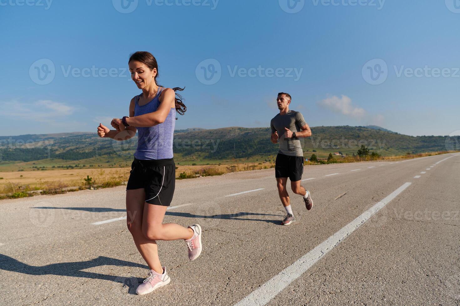 Energized by the beauty of nature, a couple powers through their morning run, their bodies and spirits invigorated. photo