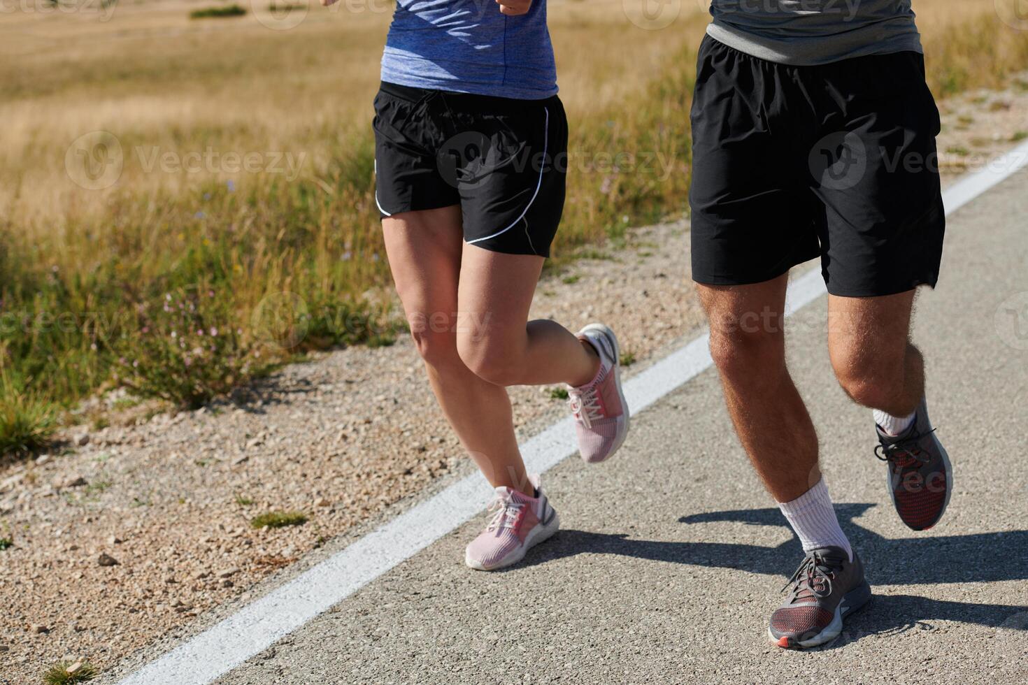Energized by the beauty of nature, a couple powers through their morning run, their bodies and spirits invigorated. photo