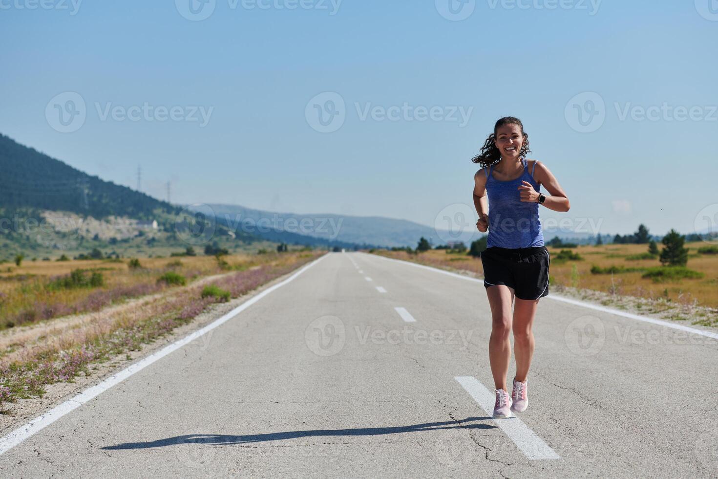 A determined woman athlete trains for success in the morning sun. photo