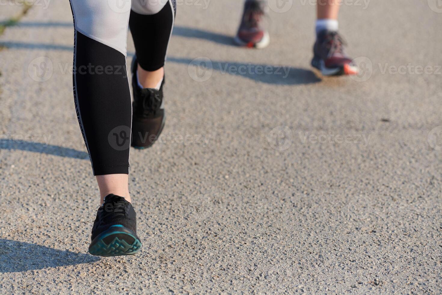 Close-Up. Athletic Runner's Legs Captured in Action on a Sunny Day. photo
