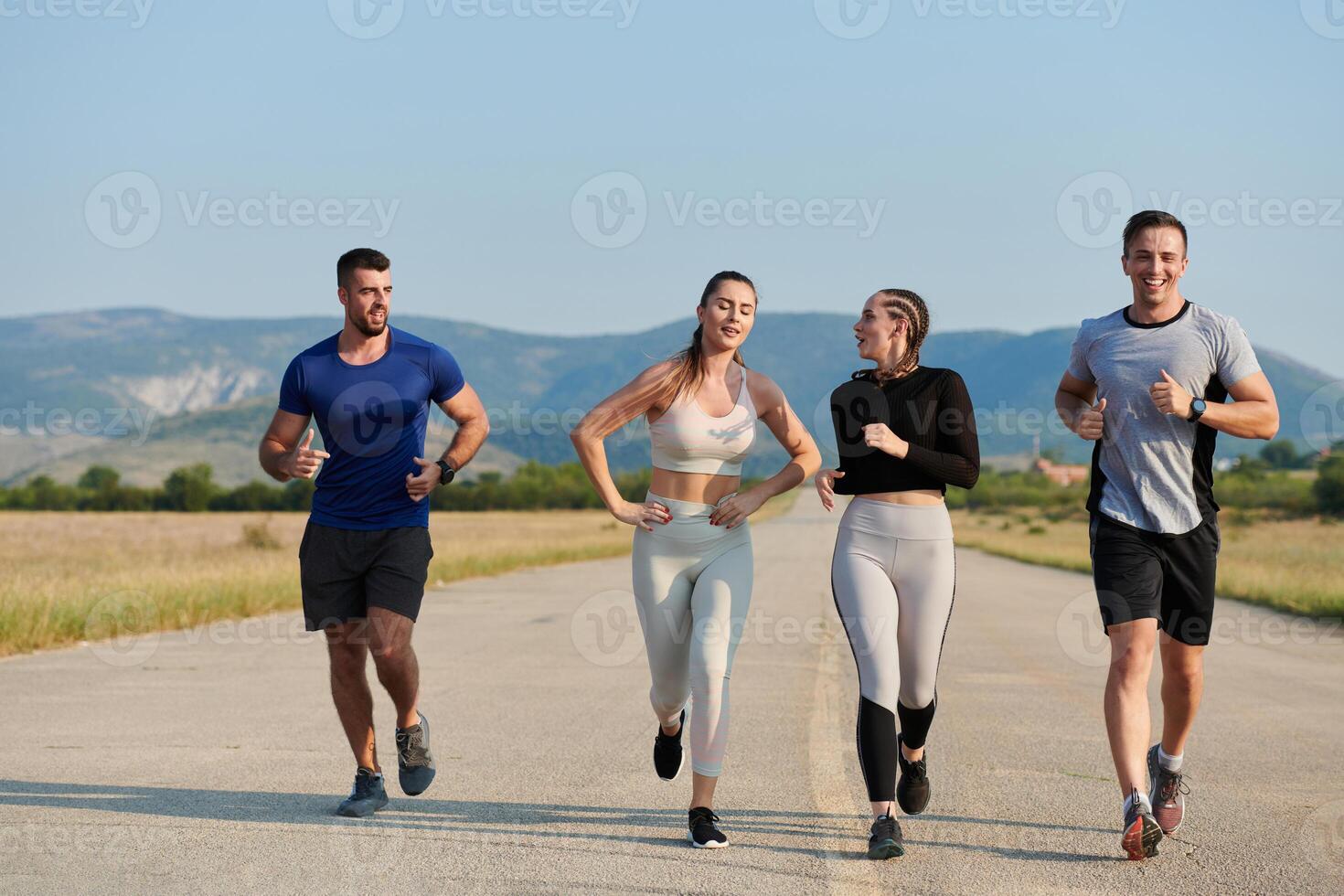 A group of friends maintains a healthy lifestyle by running outdoors on a sunny day, bonding over fitness and enjoying the energizing effects of exercise and nature photo