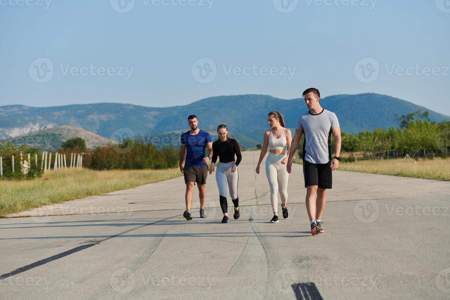 A group of friends maintains a healthy lifestyle by running outdoors on a sunny day, bonding over fitness and enjoying the energizing effects of exercise and nature photo