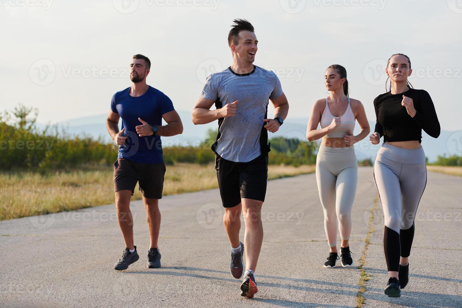 A group of friends maintains a healthy lifestyle by running outdoors on a sunny day, bonding over fitness and enjoying the energizing effects of exercise and nature photo