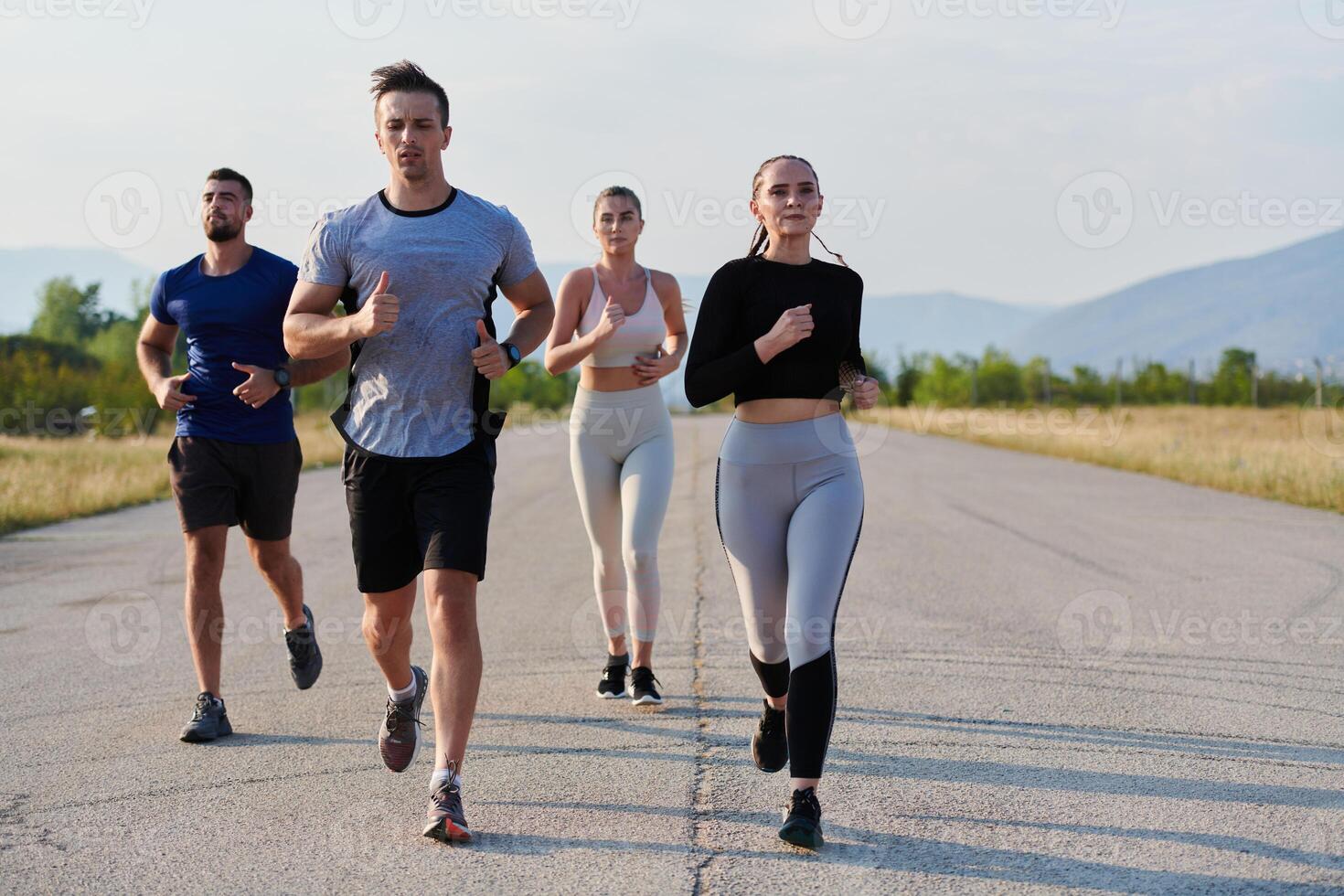 A group of friends maintains a healthy lifestyle by running outdoors on a sunny day, bonding over fitness and enjoying the energizing effects of exercise and nature photo