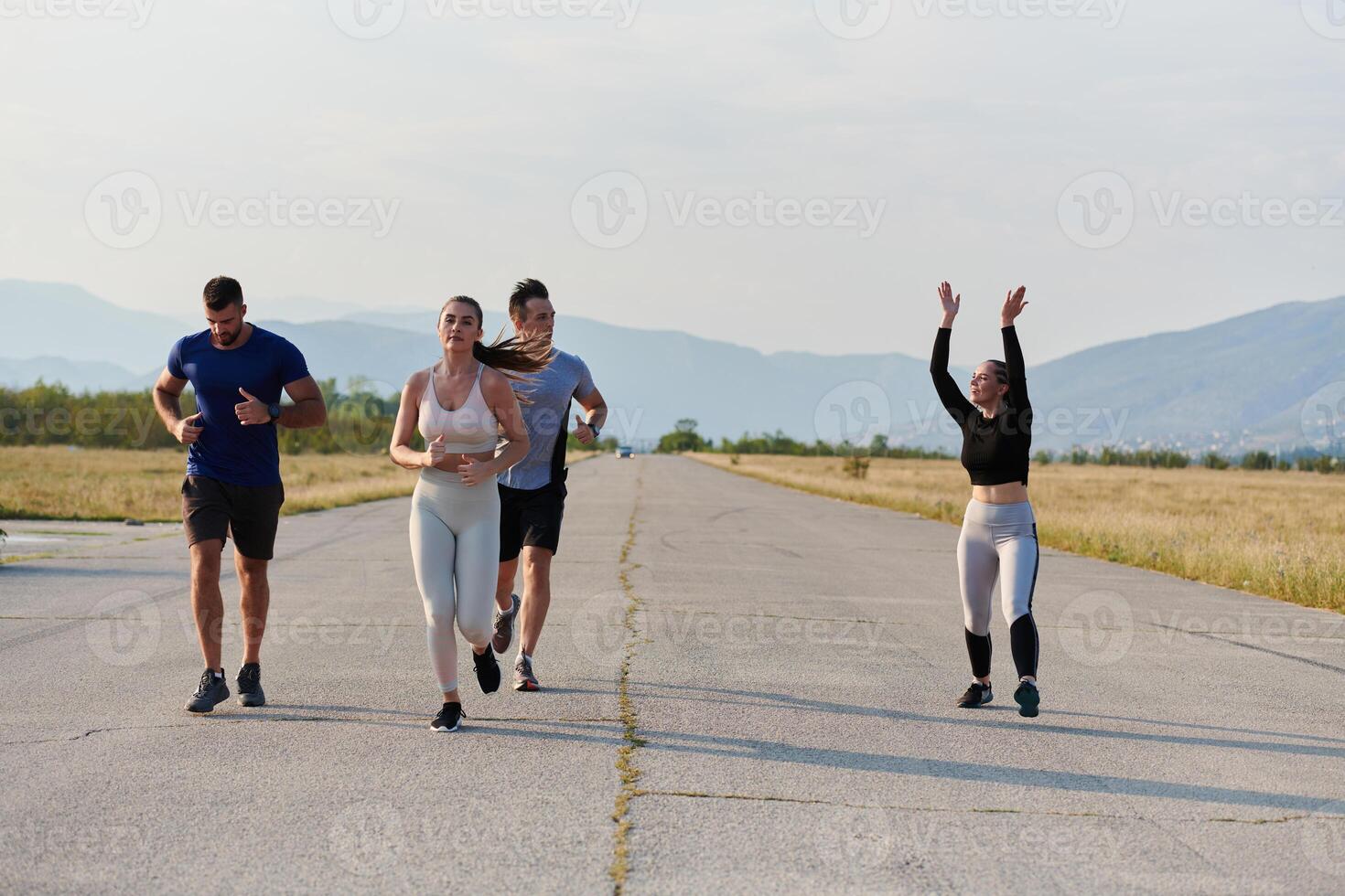 A group of friends maintains a healthy lifestyle by running outdoors on a sunny day, bonding over fitness and enjoying the energizing effects of exercise and nature photo