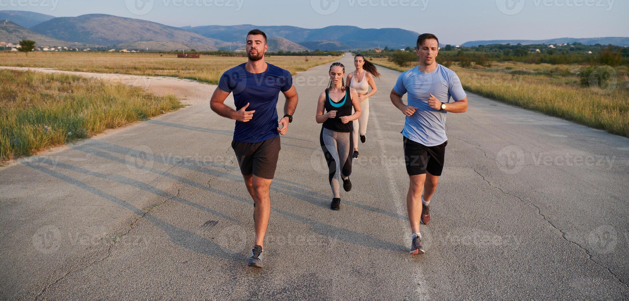 A group of friends maintains a healthy lifestyle by running outdoors on a sunny day, bonding over fitness and enjoying the energizing effects of exercise and nature photo