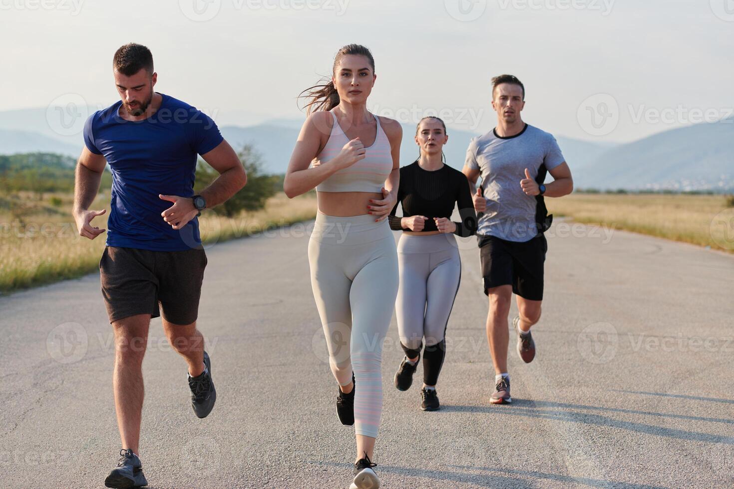 A group of friends maintains a healthy lifestyle by running outdoors on a sunny day, bonding over fitness and enjoying the energizing effects of exercise and nature photo