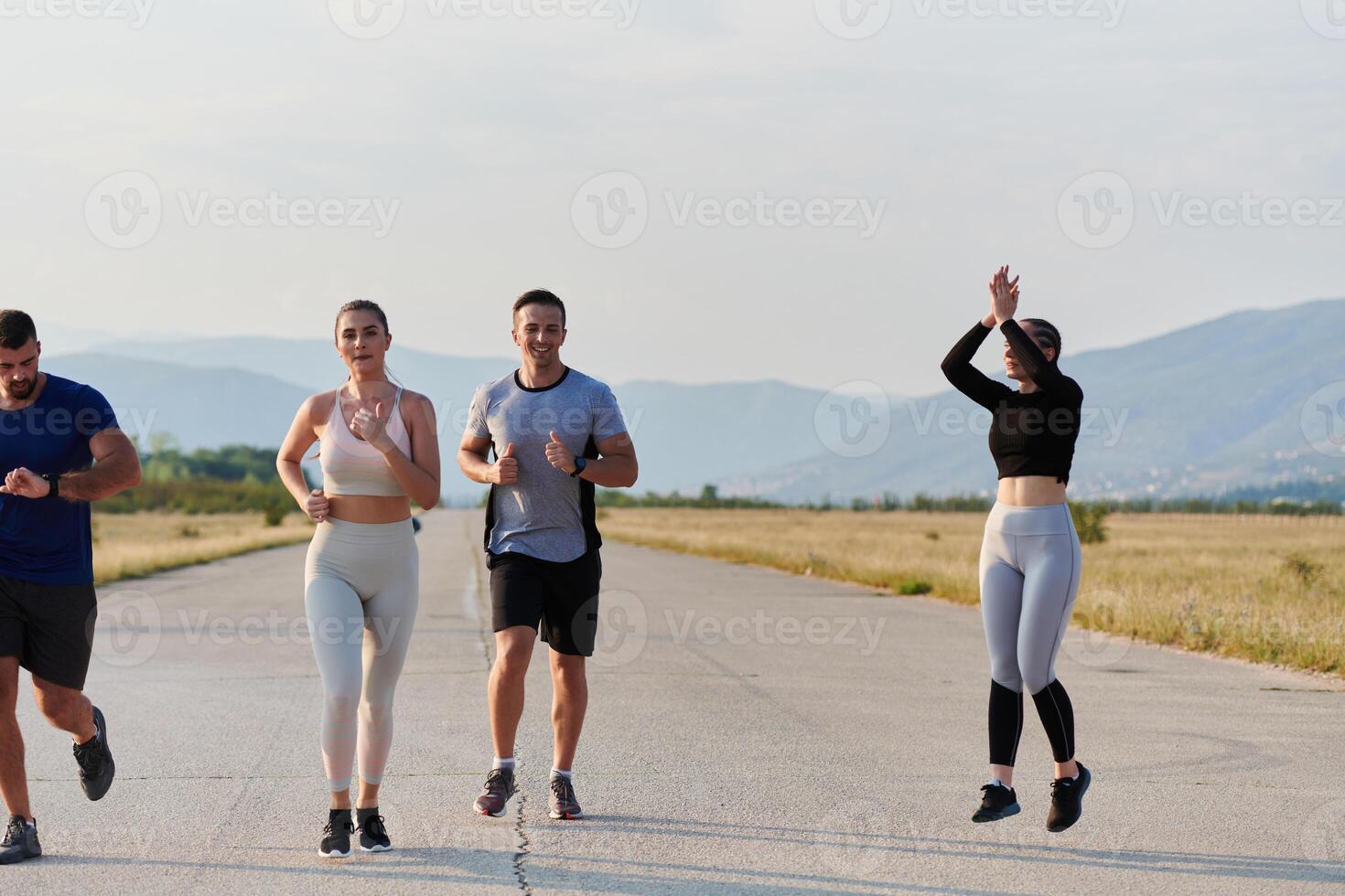 A group of friends maintains a healthy lifestyle by running outdoors on a sunny day, bonding over fitness and enjoying the energizing effects of exercise and nature photo