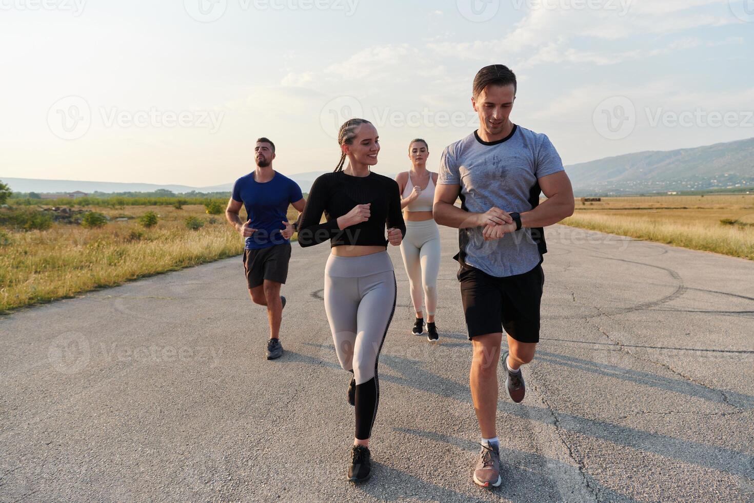 A group of friends maintains a healthy lifestyle by running outdoors on a sunny day, bonding over fitness and enjoying the energizing effects of exercise and nature photo