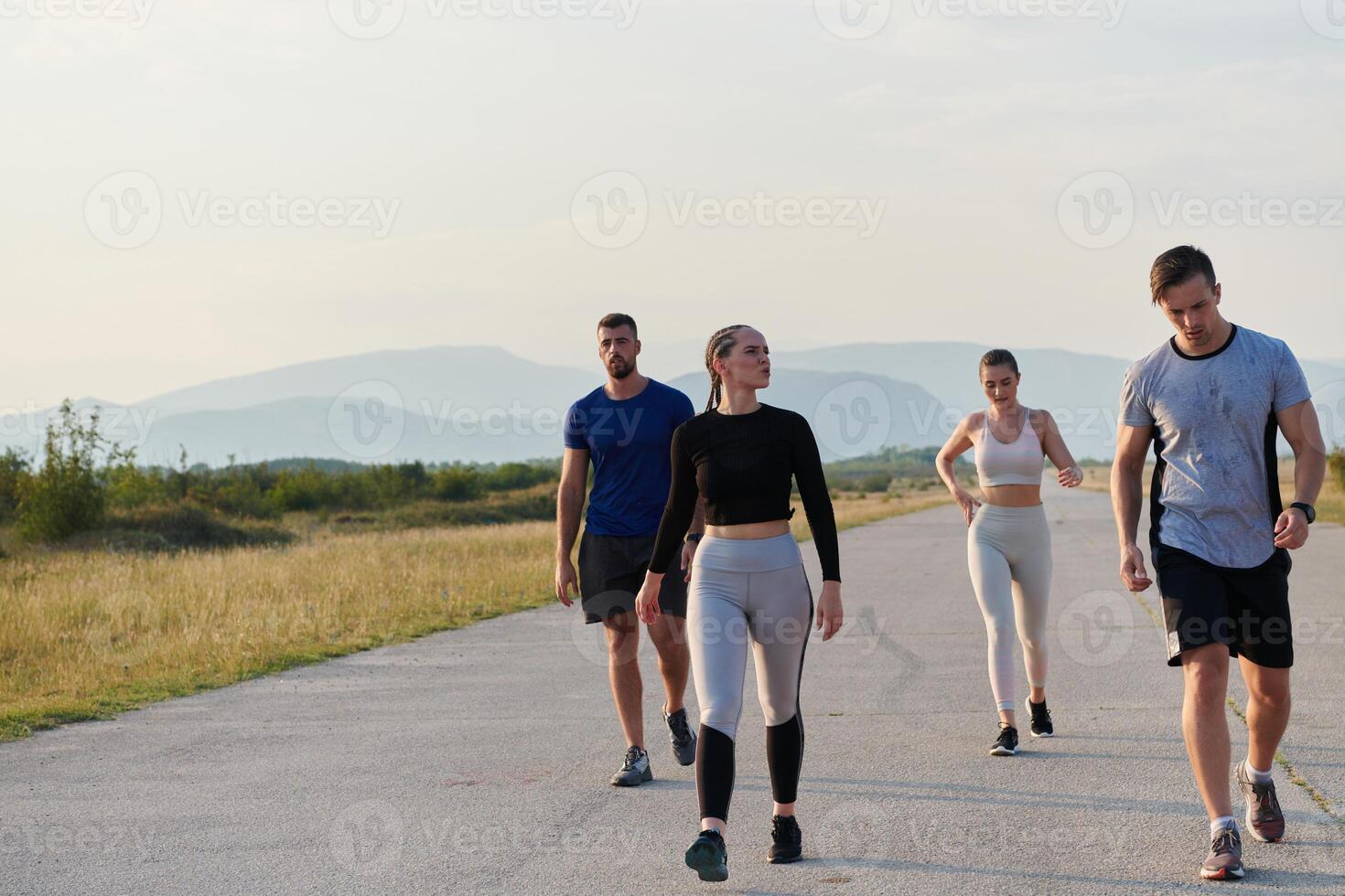 A group of friends maintains a healthy lifestyle by running outdoors on a sunny day, bonding over fitness and enjoying the energizing effects of exercise and nature photo