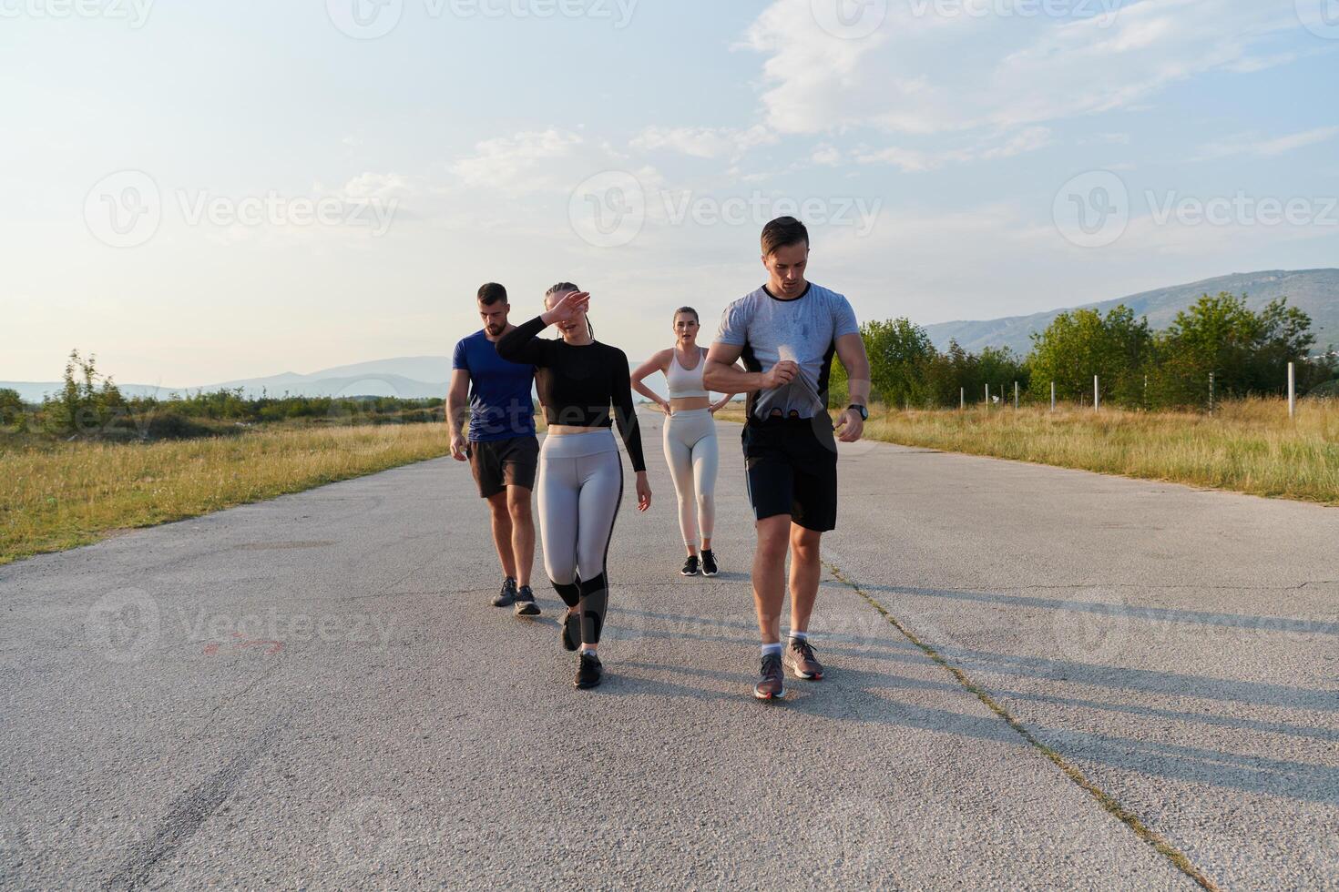 A group of friends maintains a healthy lifestyle by running outdoors on a sunny day, bonding over fitness and enjoying the energizing effects of exercise and nature photo