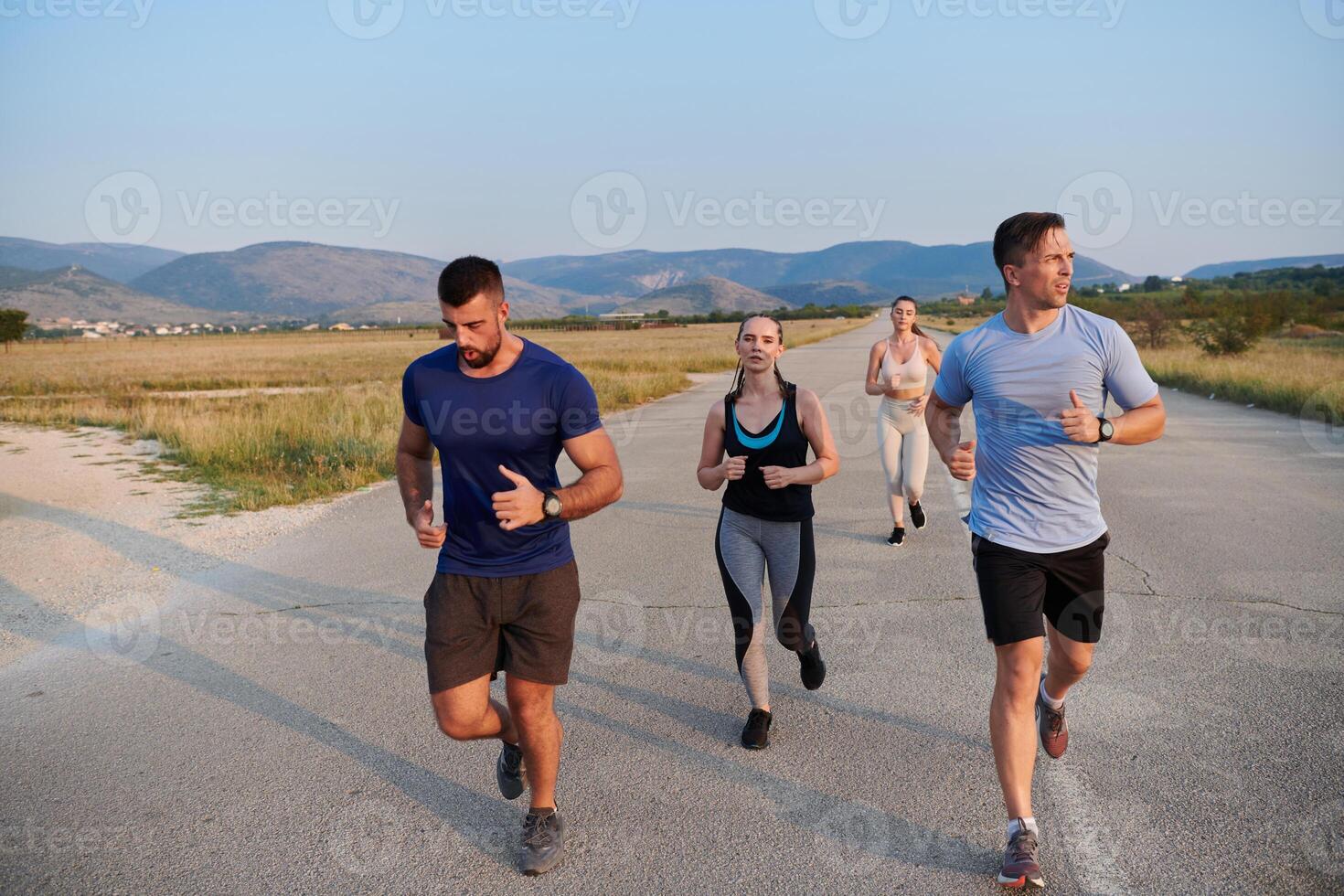 A group of friends maintains a healthy lifestyle by running outdoors on a sunny day, bonding over fitness and enjoying the energizing effects of exercise and nature photo