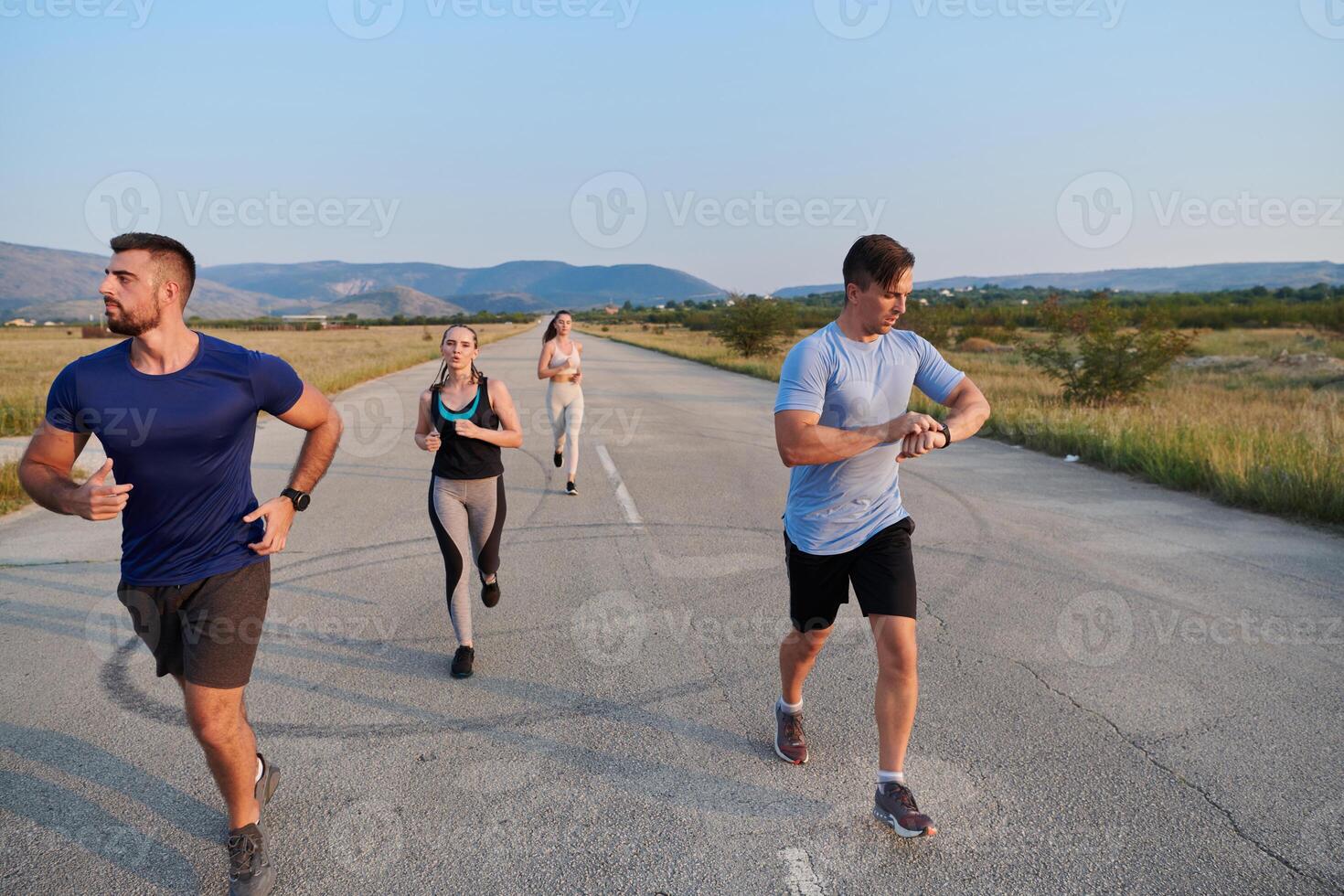 A group of friends maintains a healthy lifestyle by running outdoors on a sunny day, bonding over fitness and enjoying the energizing effects of exercise and nature photo