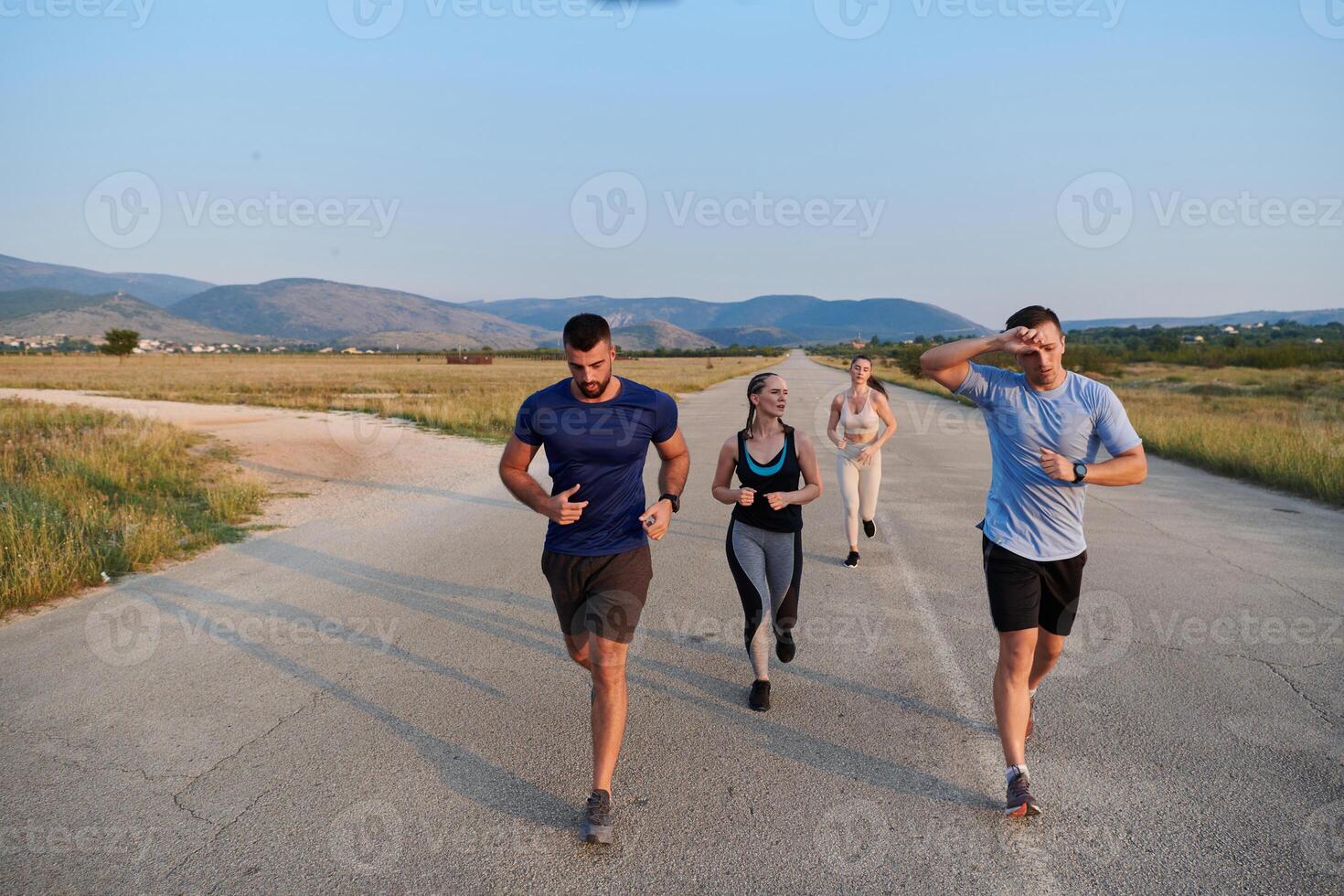 A group of friends maintains a healthy lifestyle by running outdoors on a sunny day, bonding over fitness and enjoying the energizing effects of exercise and nature photo