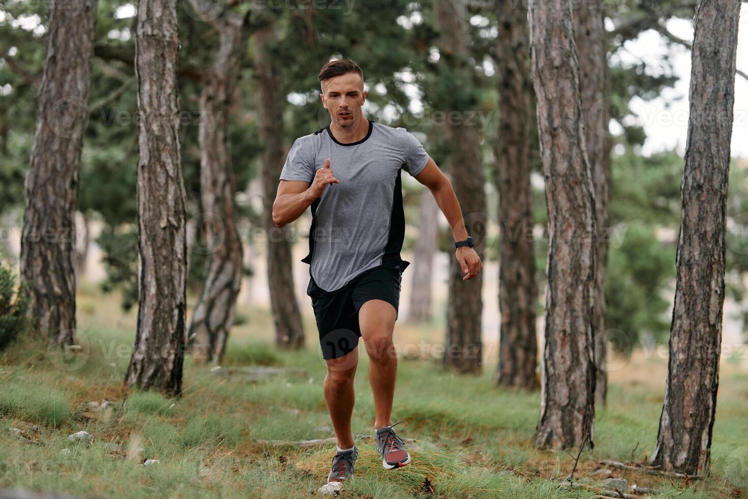 Determined Man Conquering Forest Obstacles with Grit and Speed photo