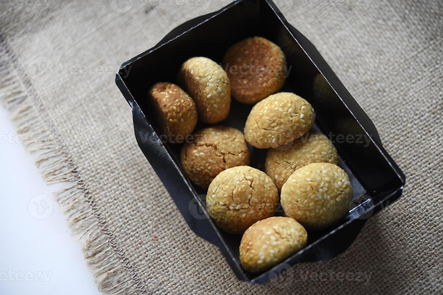 Sweet sesame cookies in cardboard boxes on burlap. Cookies in a box. photo