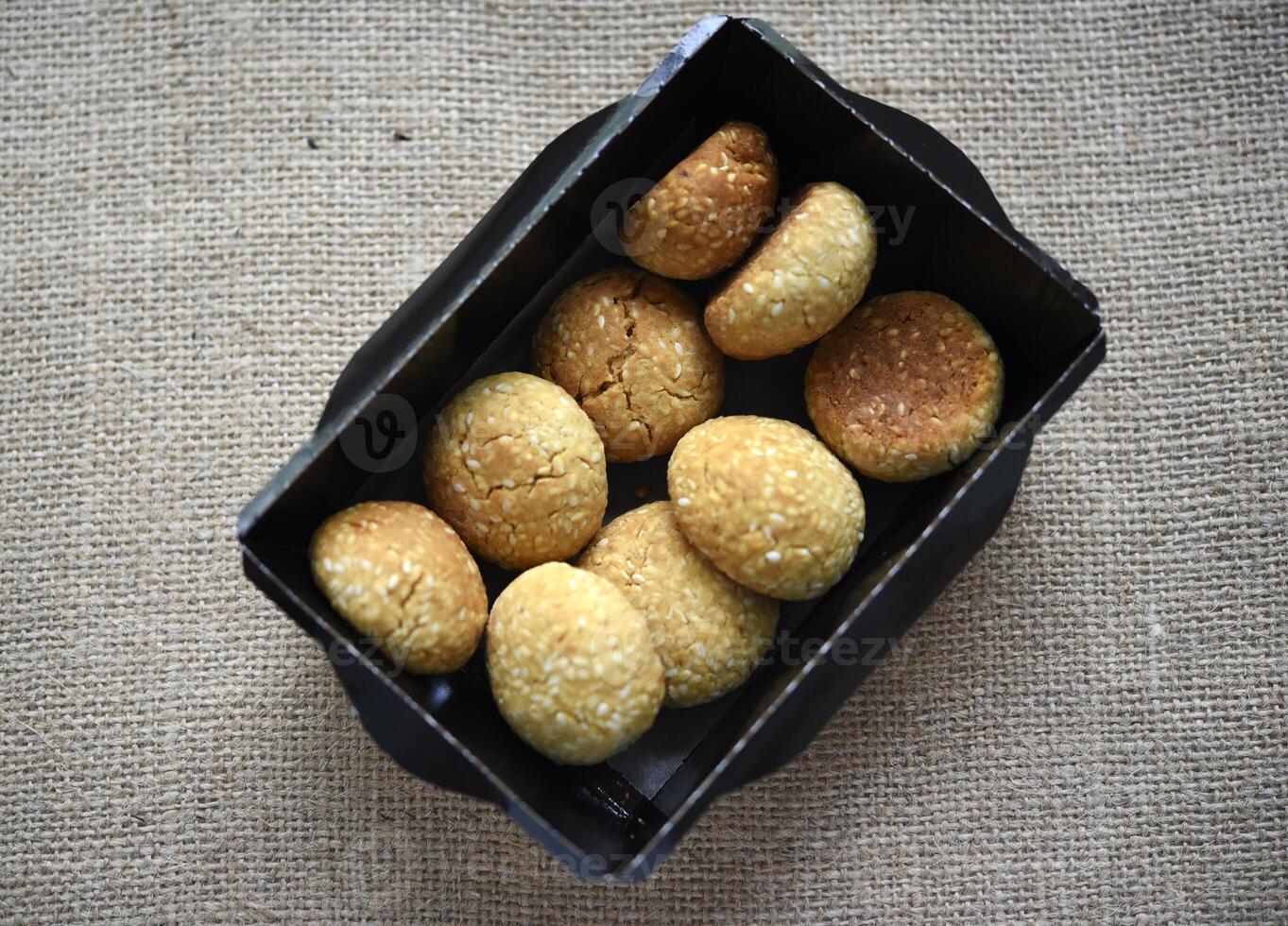 Sweet sesame cookies in cardboard boxes on burlap. Cookies in a box. photo
