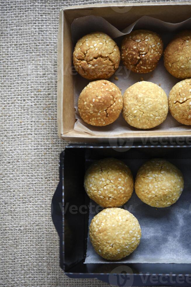Sweet sesame cookies in cardboard boxes on burlap. Cookies in a box. photo