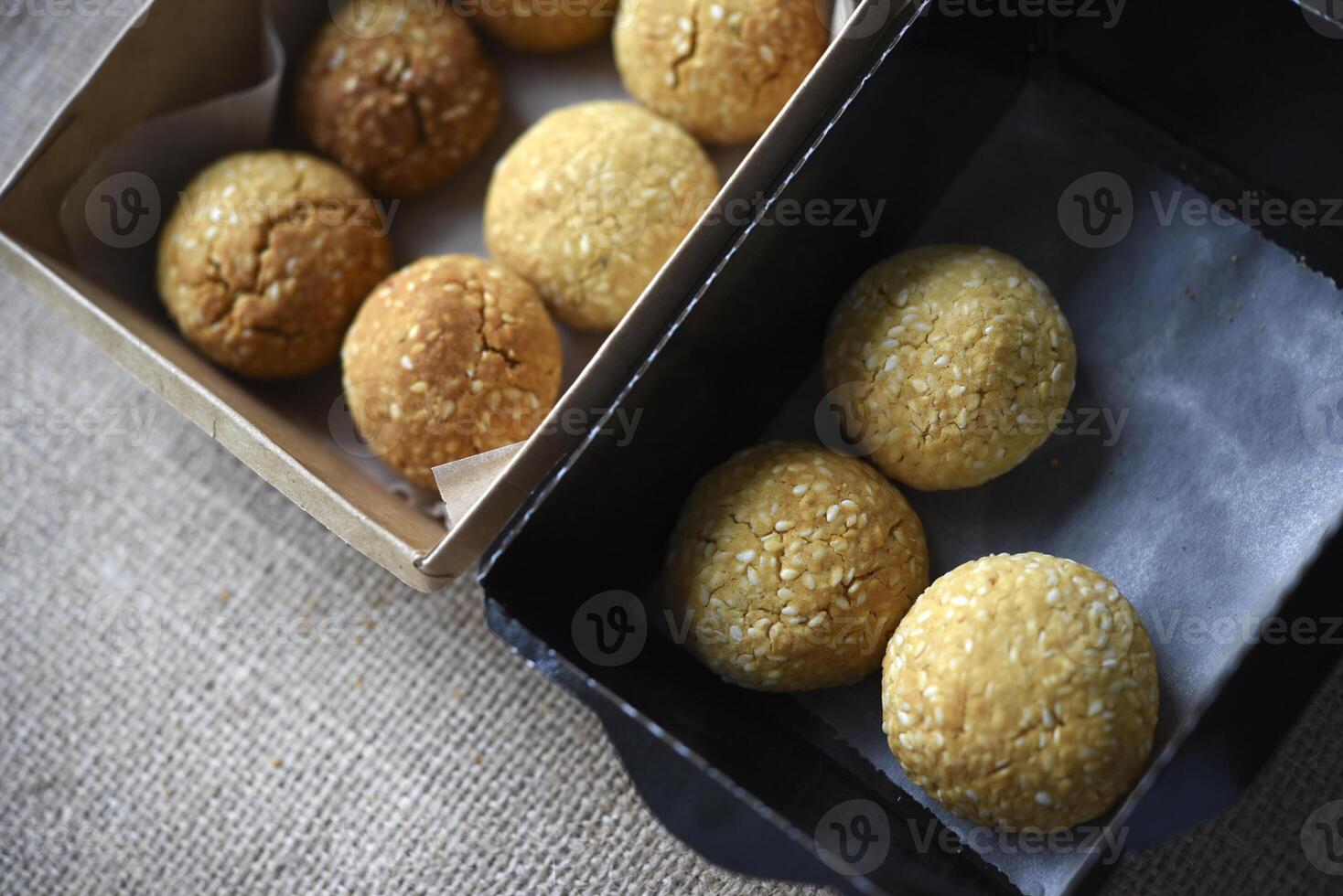 Sweet sesame cookies in cardboard boxes on burlap. Cookies in a box. photo