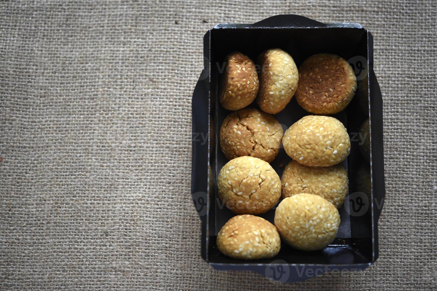 Sweet sesame cookies in cardboard boxes on burlap. Cookies in a box. photo