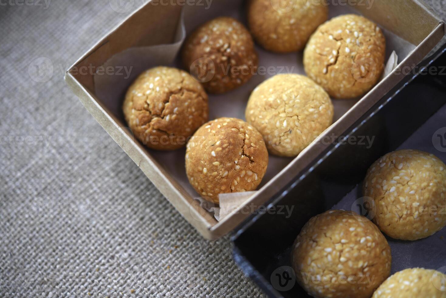 Sweet sesame cookies in cardboard boxes on burlap. Cookies in a box. photo