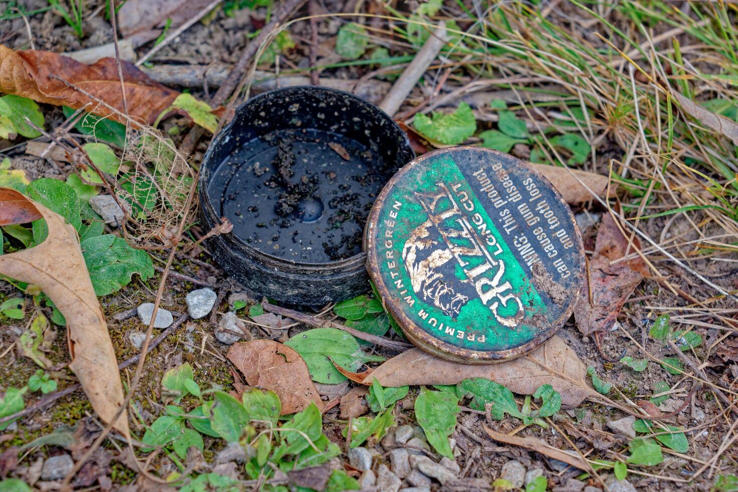 Crossville, Tennessee USA - October 14, 2023 Empty chew tobacco container on the ground photo