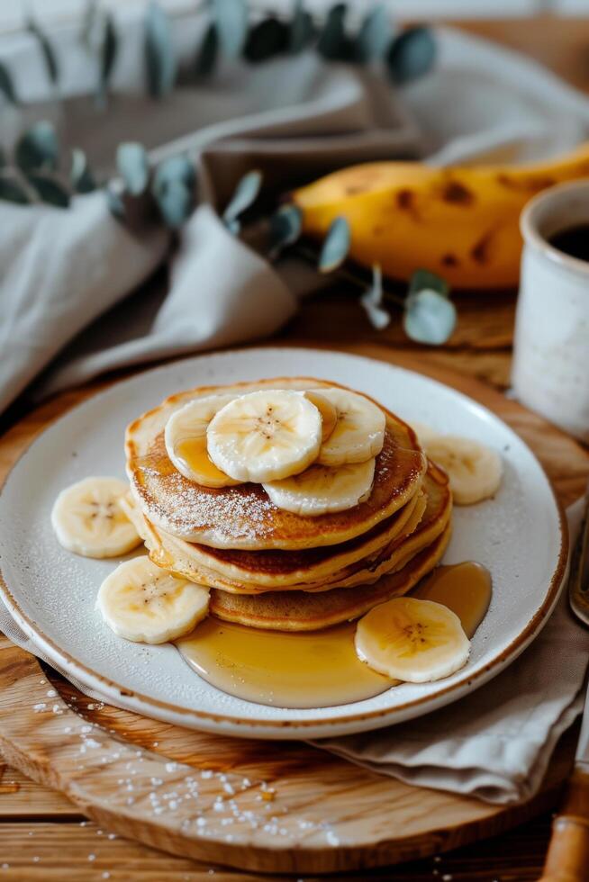 Stack of Pancakes With Bananas and Syrup photo