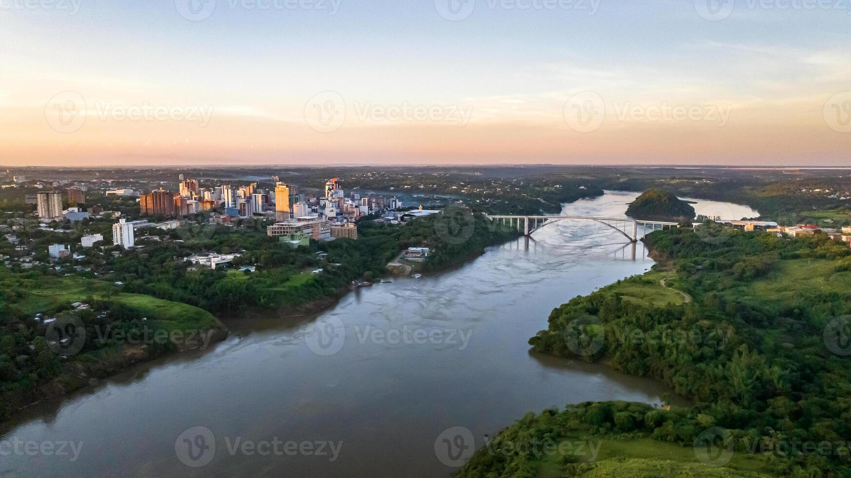 Border between Brazil and Paraguay and connects Foz do Iguacu to Ciudad del Este. Ponte da Amizade in Foz do Iguacu. Aerial view of the Friendship Bridge with Parana river. photo