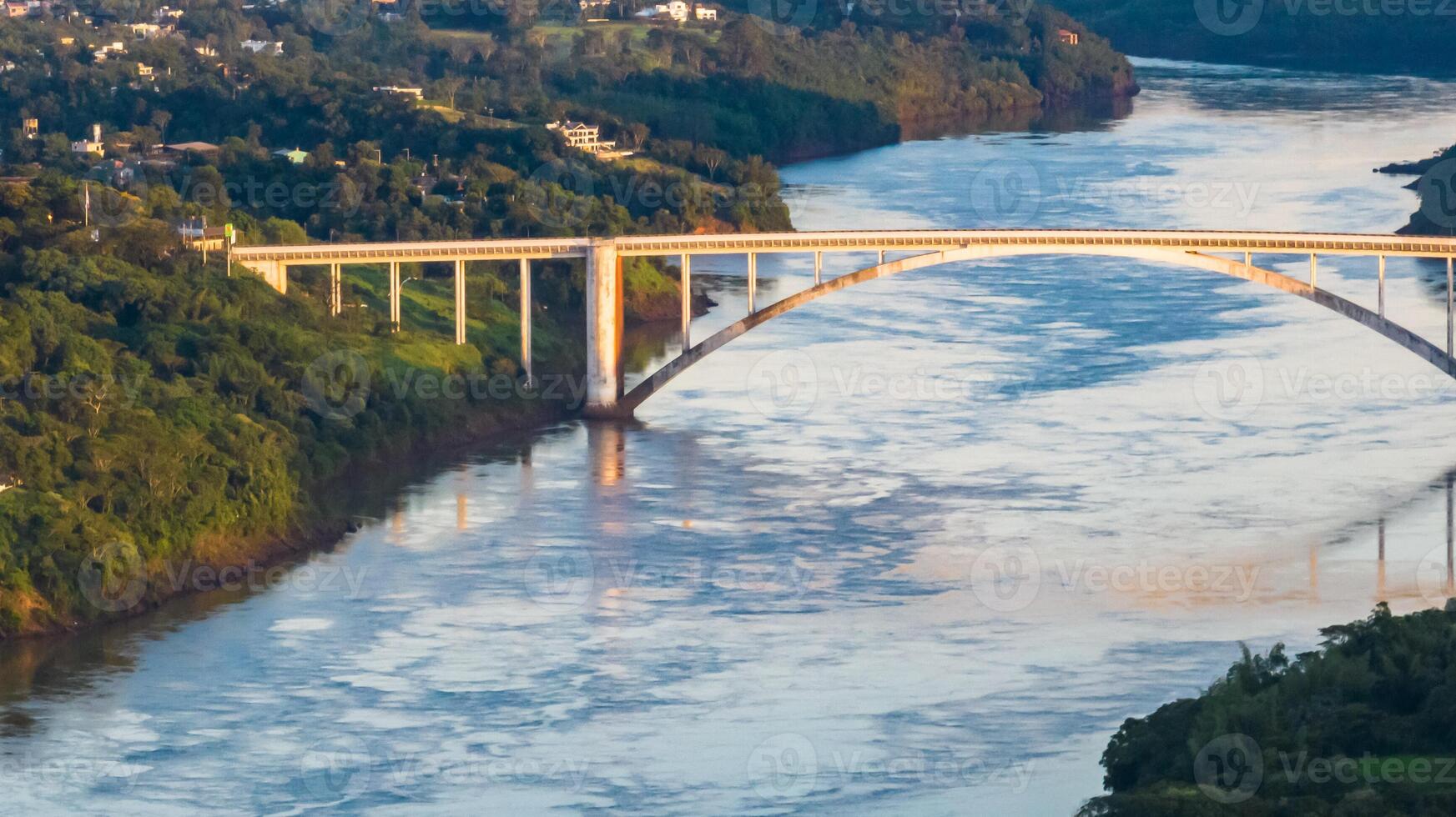 Border between Brazil and Paraguay and connects Foz do Iguacu to Ciudad del Este. Ponte da Amizade in Foz do Iguacu. Aerial view of the Friendship Bridge with Parana river. photo