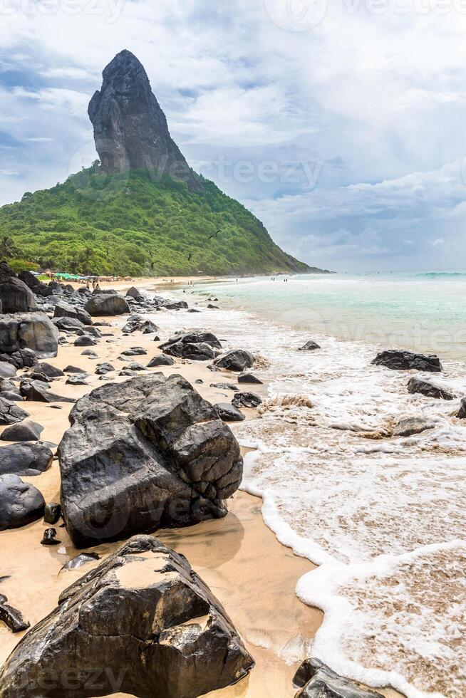Fernando de Noronha, Brazil. Beach of Conceicao. Conceicao with rocks in the foreground. photo